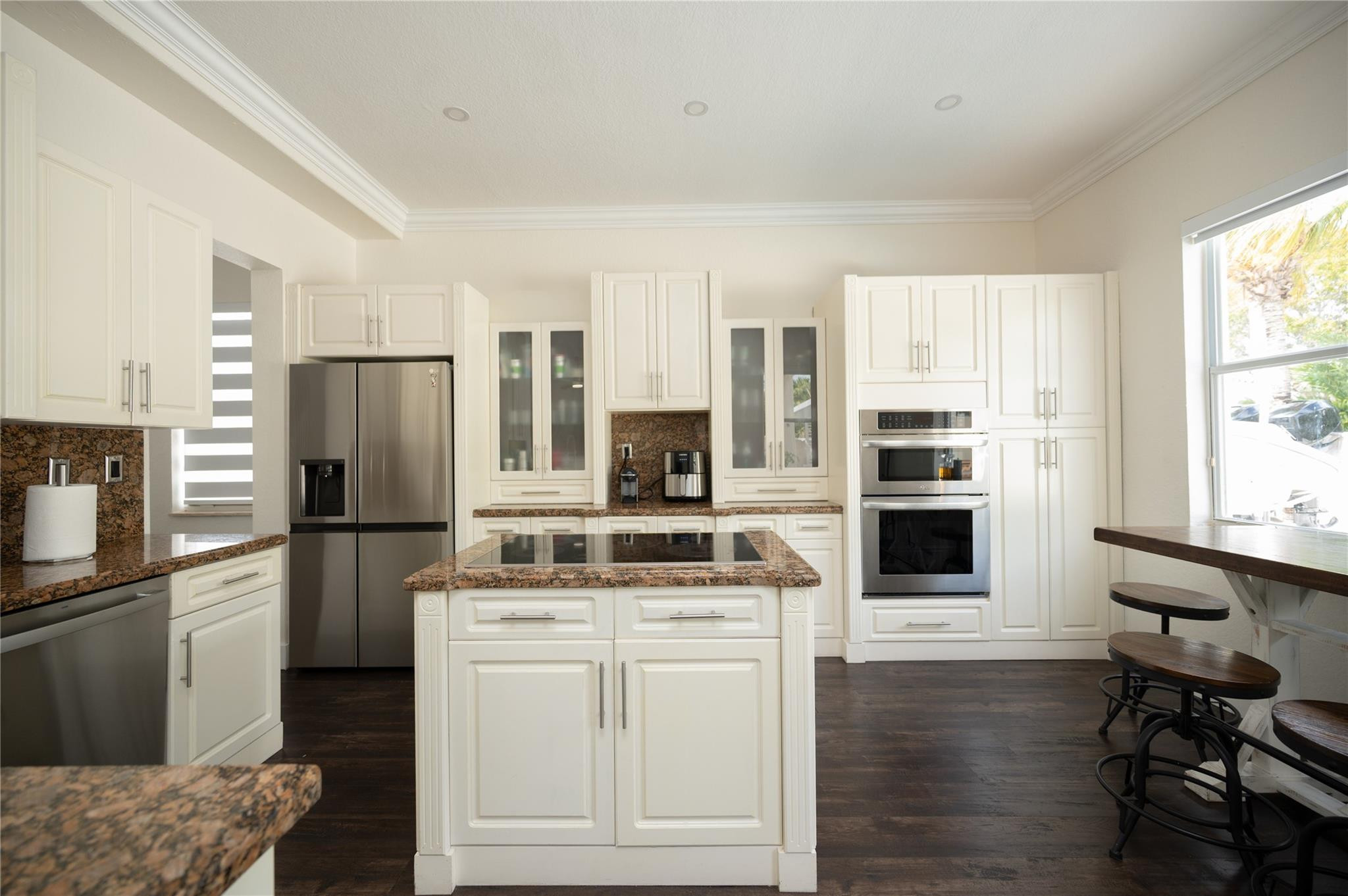 8891 Northwest 178th Lane Hialeah, FL 33018 - Photo 9 of 42 a kitchen with white cabinets and stainless steel appliances