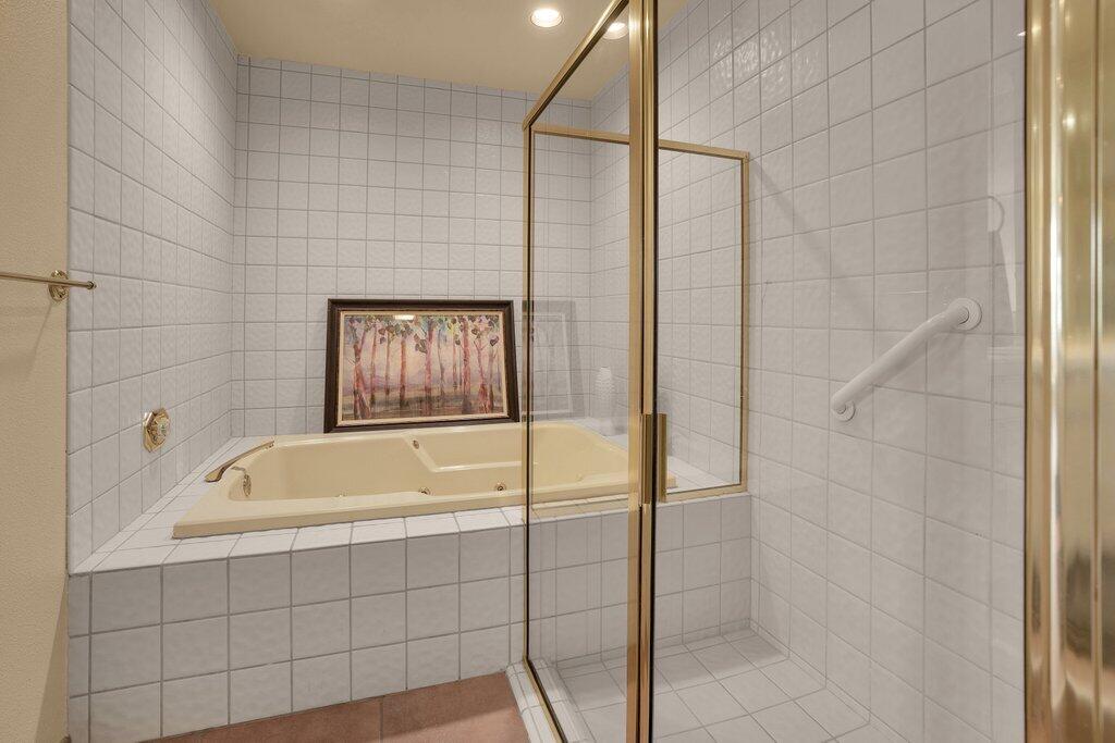 9 Lakeshore Drive Rancho Mirage, CA 92270 - Photo 12 of 41 a bathroom with a tub and a shower