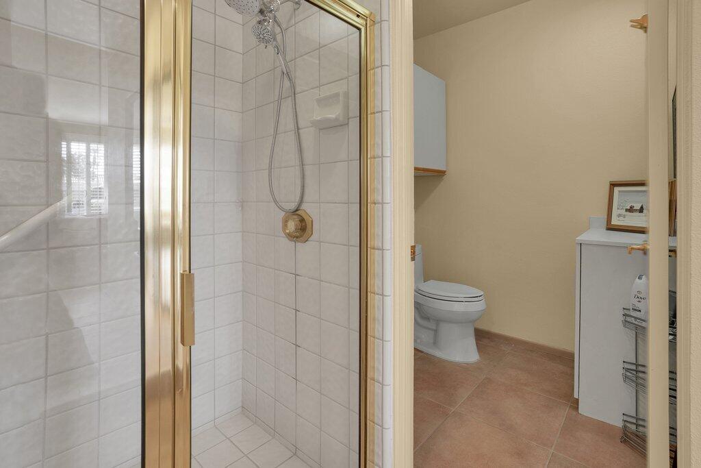 9 Lakeshore Drive Rancho Mirage, CA 92270 - Photo 13 of 41 a bathroom with a toilet and a shower