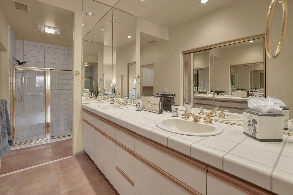 9 Lakeshore Drive Rancho Mirage, CA 92270 - Photo 15 of 41 a bathroom with a double vanity sink mirror and shower