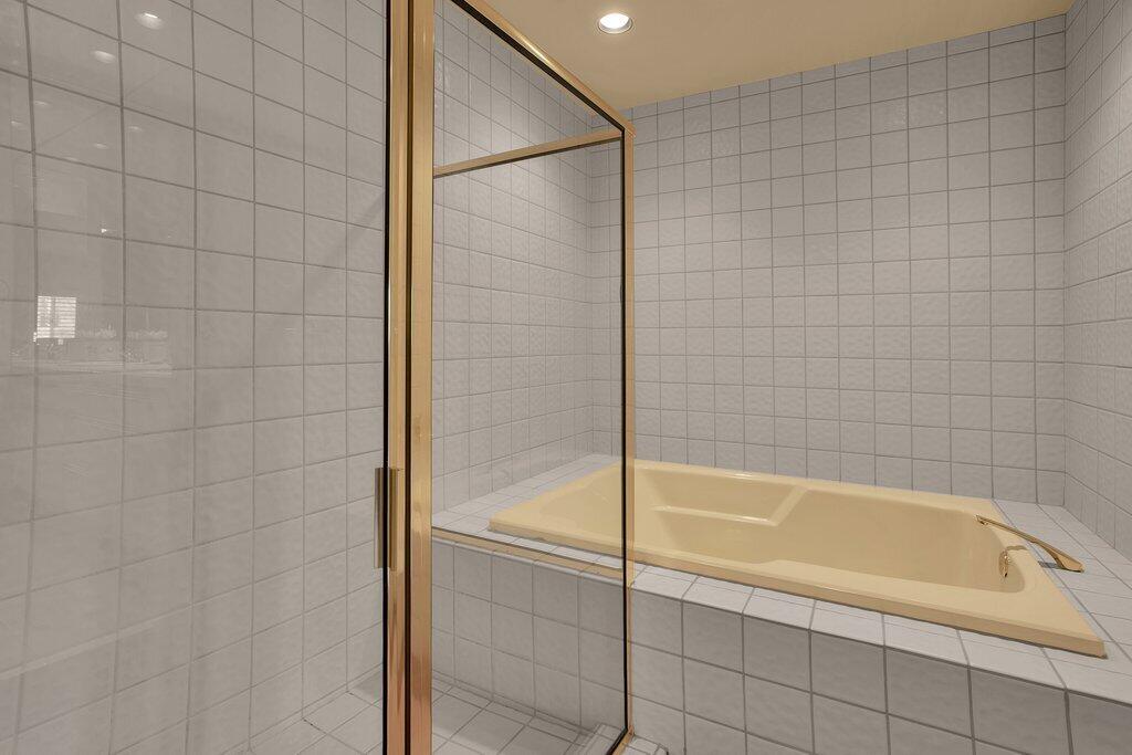 9 Lakeshore Drive Rancho Mirage, CA 92270 - Photo 16 of 41 a bathroom with a bathtub and shower