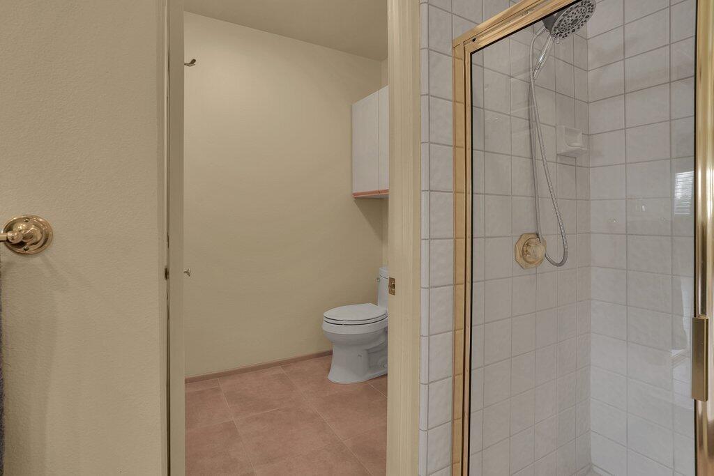 9 Lakeshore Drive Rancho Mirage, CA 92270 - Photo 17 of 41 a bathroom with a granite countertop toilet and a shower