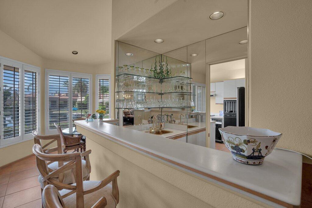9 Lakeshore Drive Rancho Mirage, CA 92270 - Photo 20 of 41 a dining hall with stainless steel appliances kitchen island granite countertop a sink and chairs