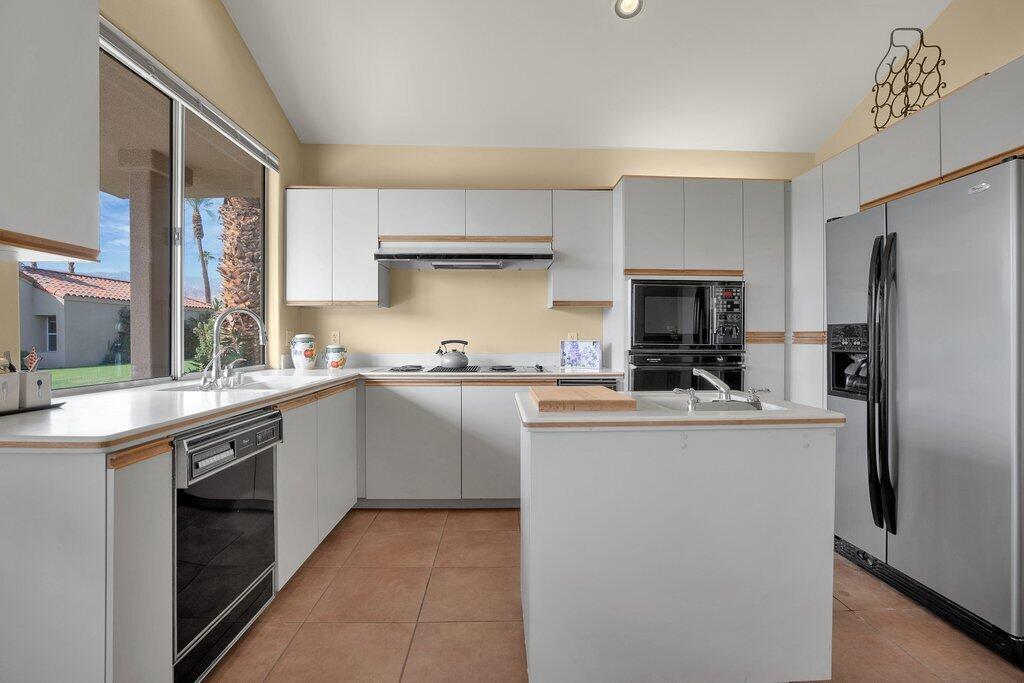 9 Lakeshore Drive Rancho Mirage, CA 92270 - Photo 22 of 41 a kitchen with a sink stove and refrigerator
