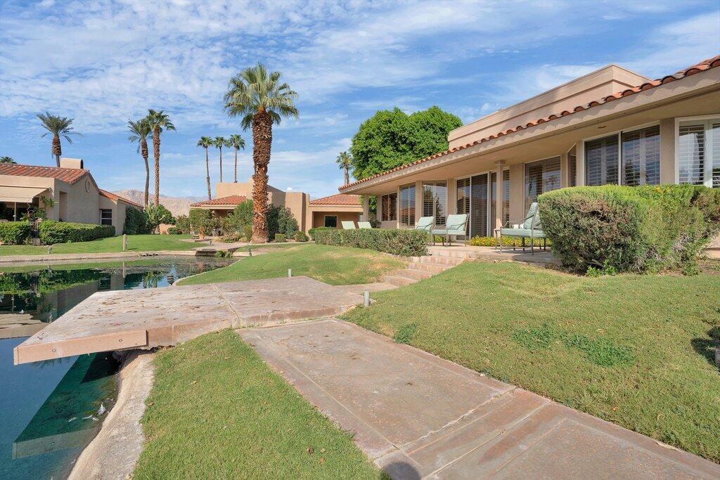 9 Lakeshore Drive Rancho Mirage, CA 92270 - Photo 29 of 41 a front view of a house with a yard and potted plants