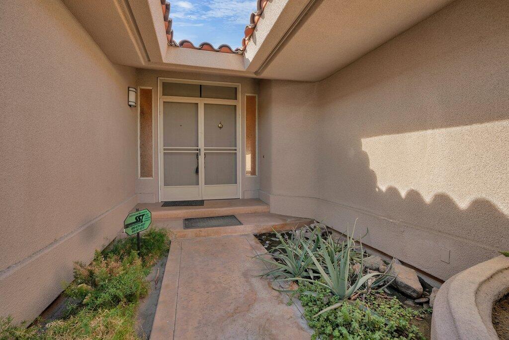 9 Lakeshore Drive Rancho Mirage, CA 92270 - Photo 7 of 41 a front view of a house with a yard
