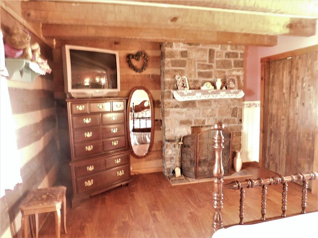 1010 Urich Road Smithton, PA 15479 - Photo 11 of 23 THE MASTER BEDROOM ALSO FEATURES A BEAUTIFUL STONE WOOD BURNING FIREPLACE...COZY AND ROMANTIC..