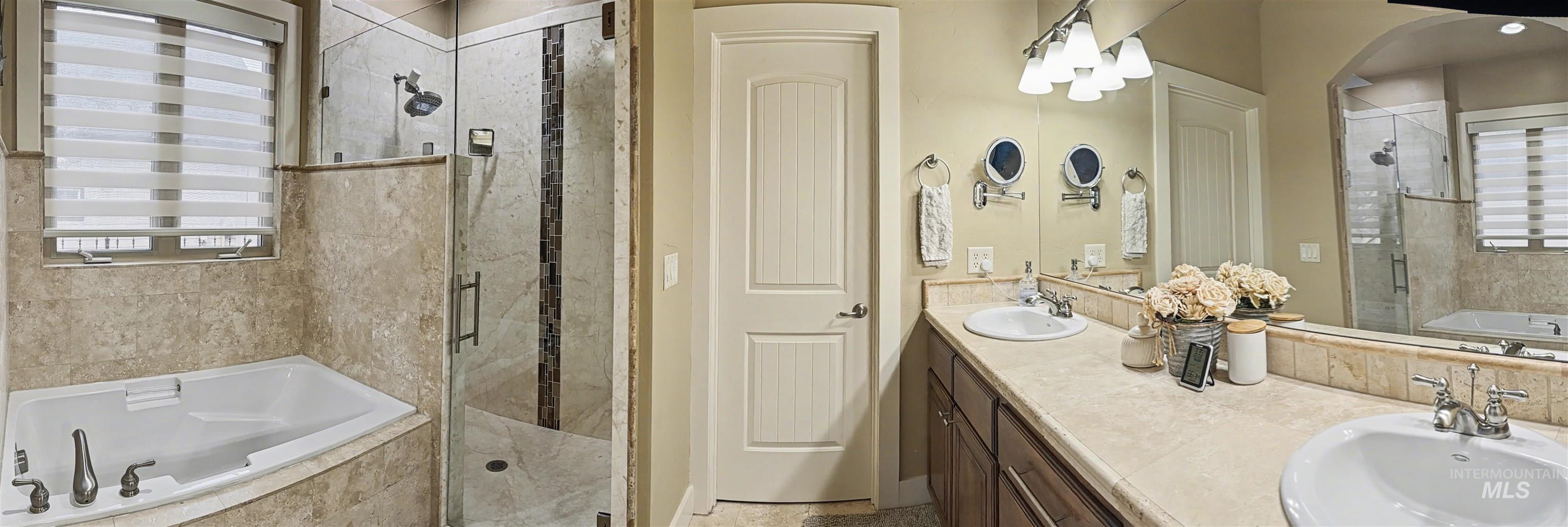 2425 South Chipper Way Eagle, ID 83616 - Photo 19 of 43 Bathroom with a bath, a stall shower, and double vanity