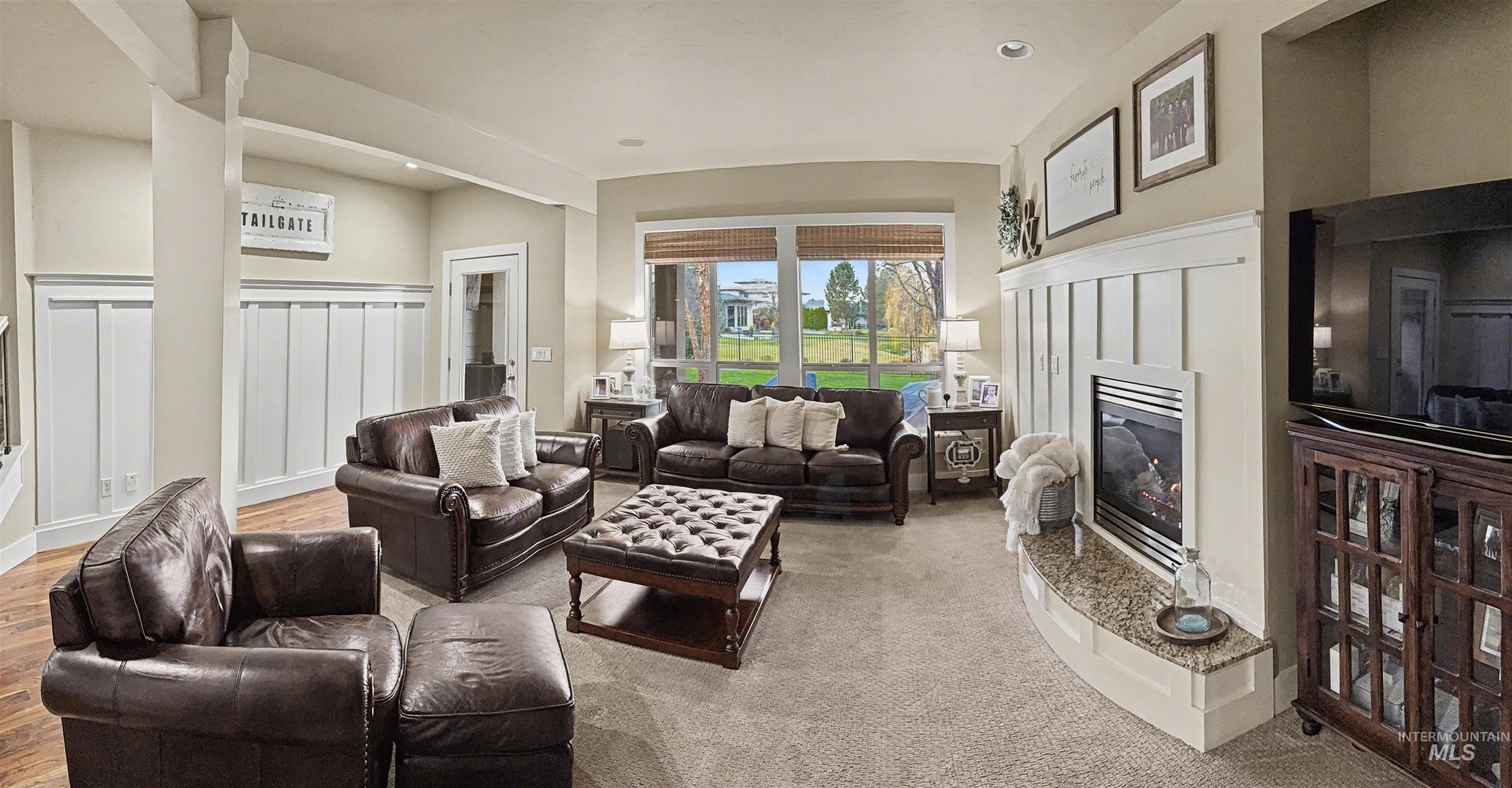 2425 South Chipper Way Eagle, ID 83616 - Photo 24 of 43 Living room featuring a glass covered fireplace and a decorative wall