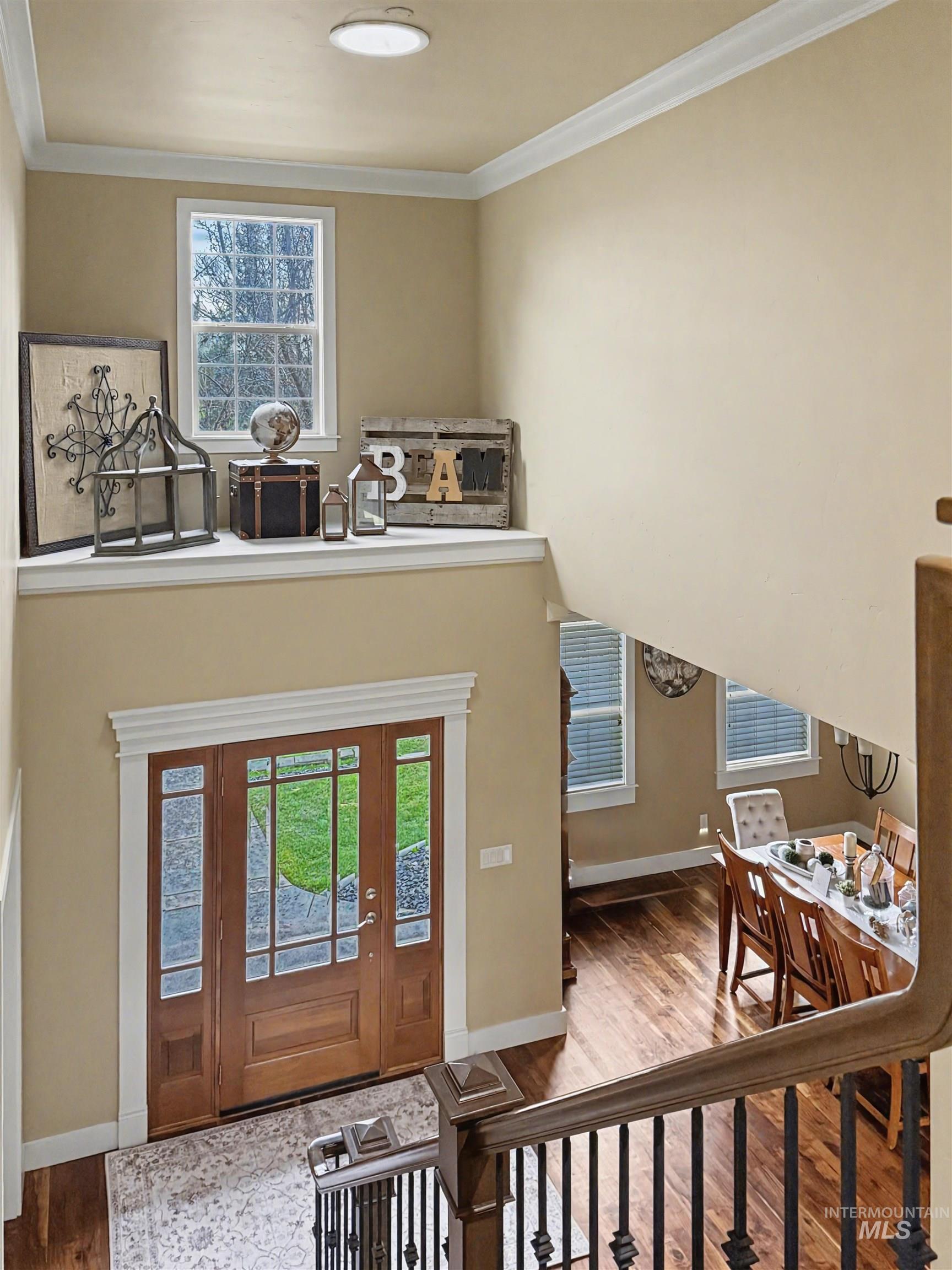 2425 South Chipper Way Eagle, ID 83616 - Photo 28 of 43 Foyer featuring wood finished floors, plenty of natural light, ornamental molding, and a high ceiling