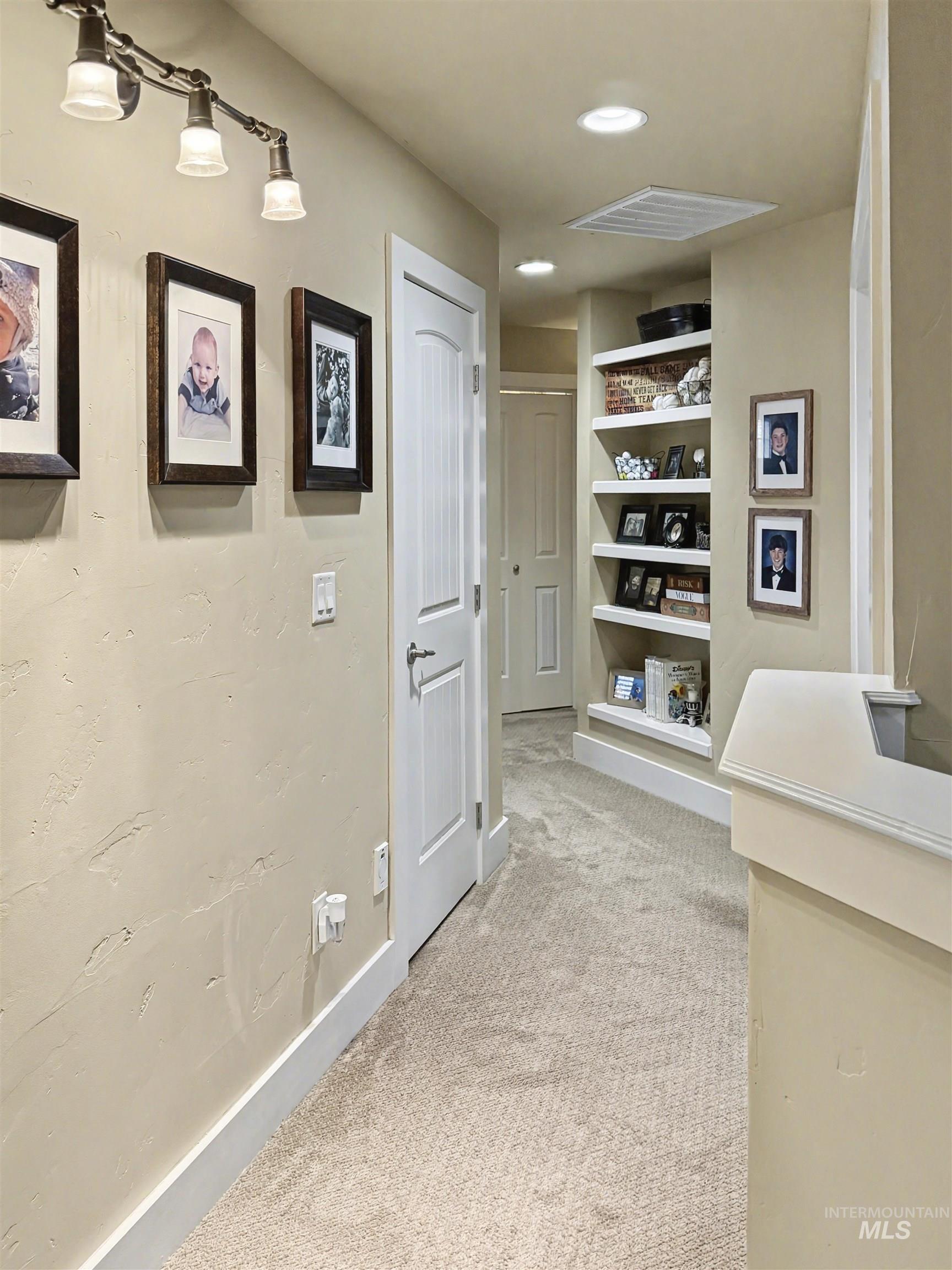 2425 South Chipper Way Eagle, ID 83616 - Photo 31 of 43 Corridor featuring light colored carpet, built in shelves, and recessed lighting