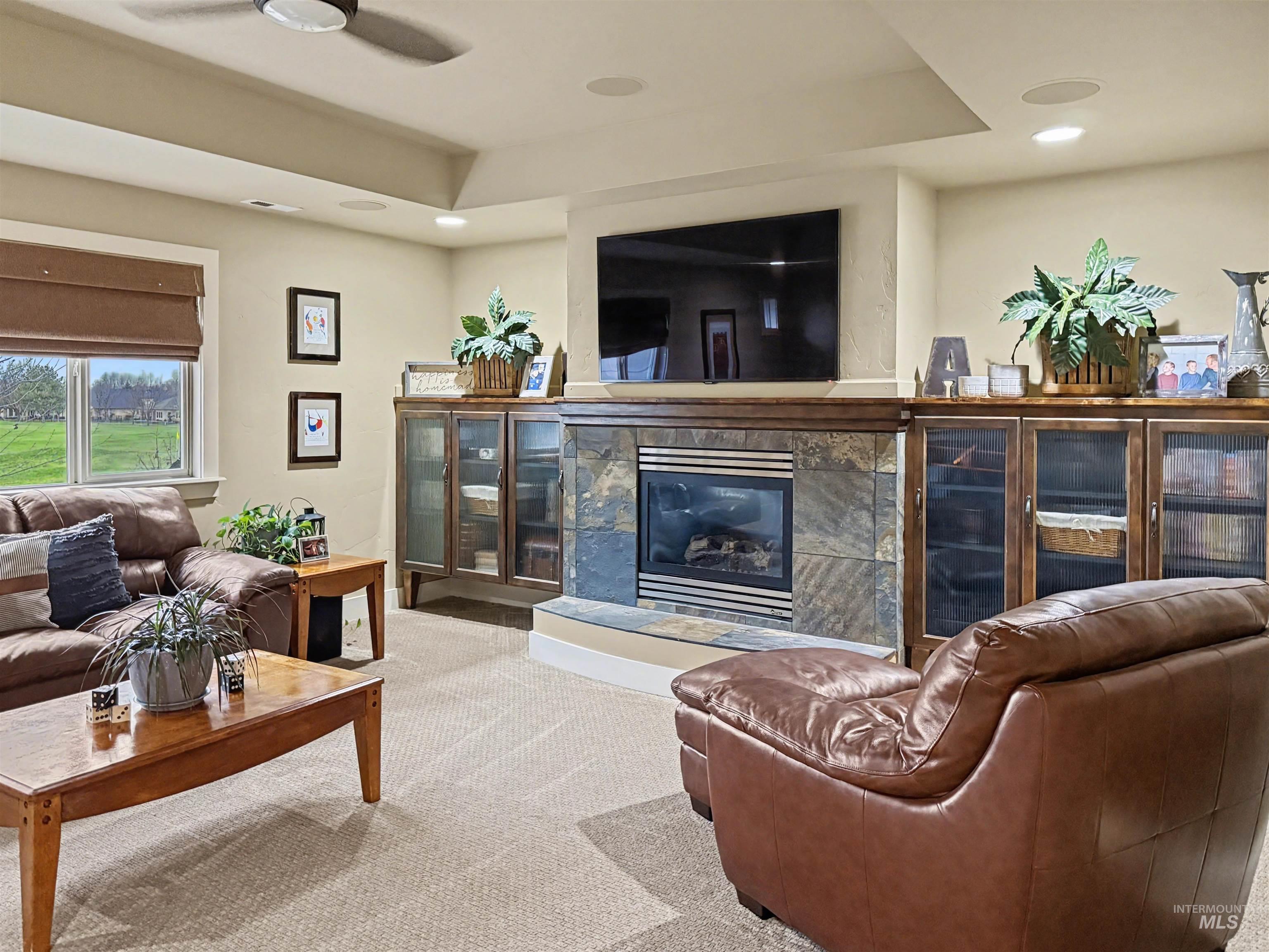 2425 South Chipper Way Eagle, ID 83616 - Photo 37 of 43 Living room with carpet flooring, a high end fireplace, recessed lighting, and a ceiling fan