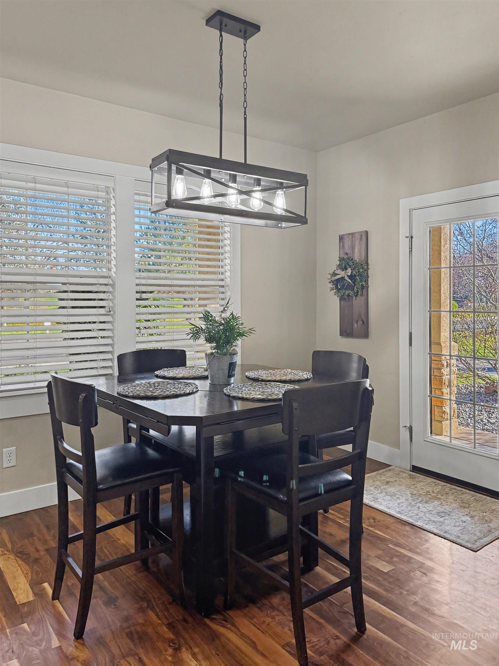 2425 South Chipper Way Eagle, ID 83616 - Photo 42 of 43 Dining room with healthy amount of natural light and dark wood-style flooring
