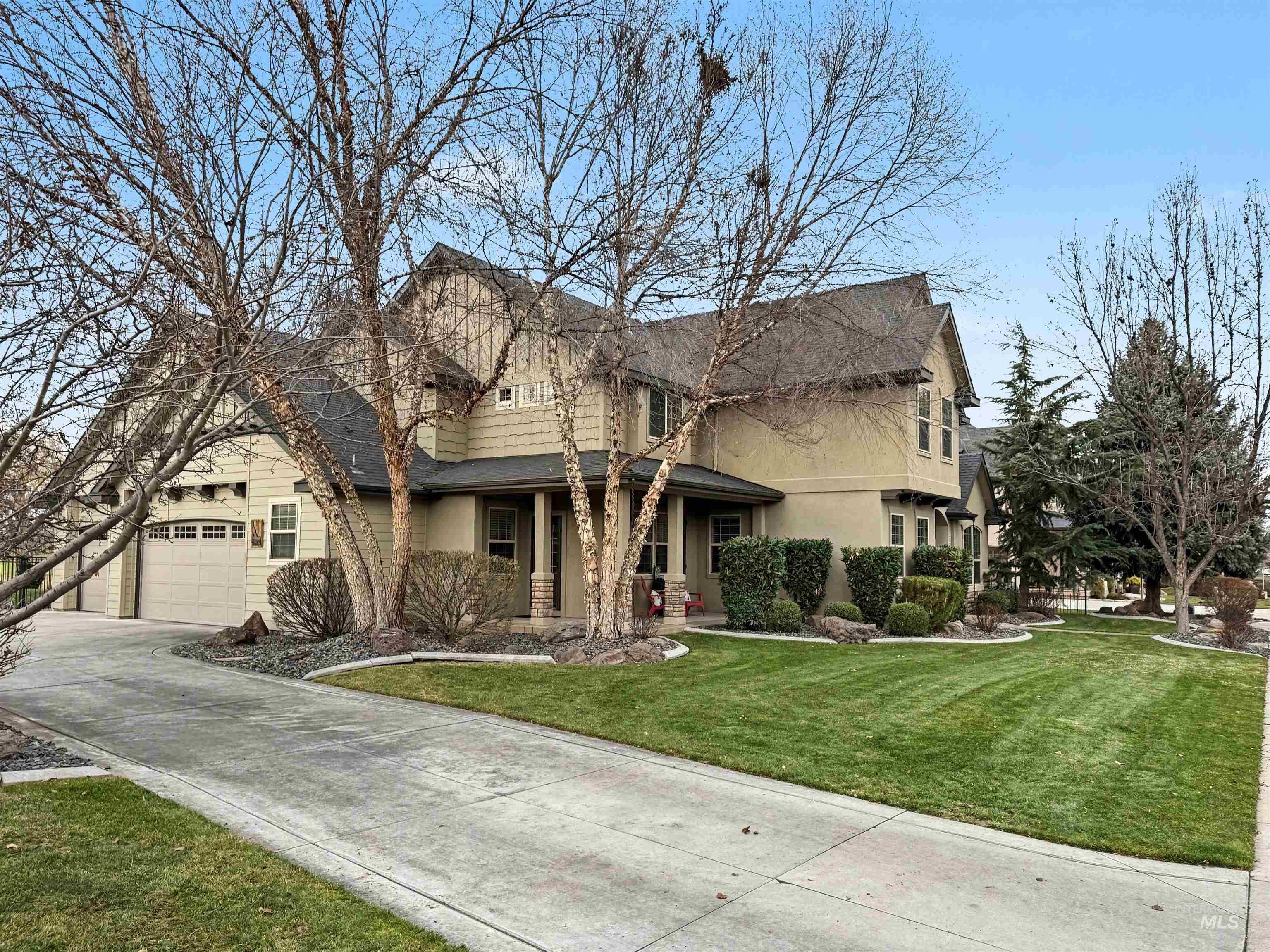 2425 South Chipper Way Eagle, ID 83616 - Photo 7 of 43 Traditional-style home featuring covered porch, a front yard, driveway, and stucco siding