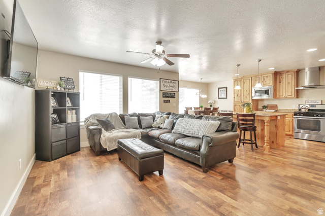 13038 Tower Ridge Drive Riverton, UT 84096 - Photo 12 of 30 Open-concept living space featuring wood-finish flooring throughout