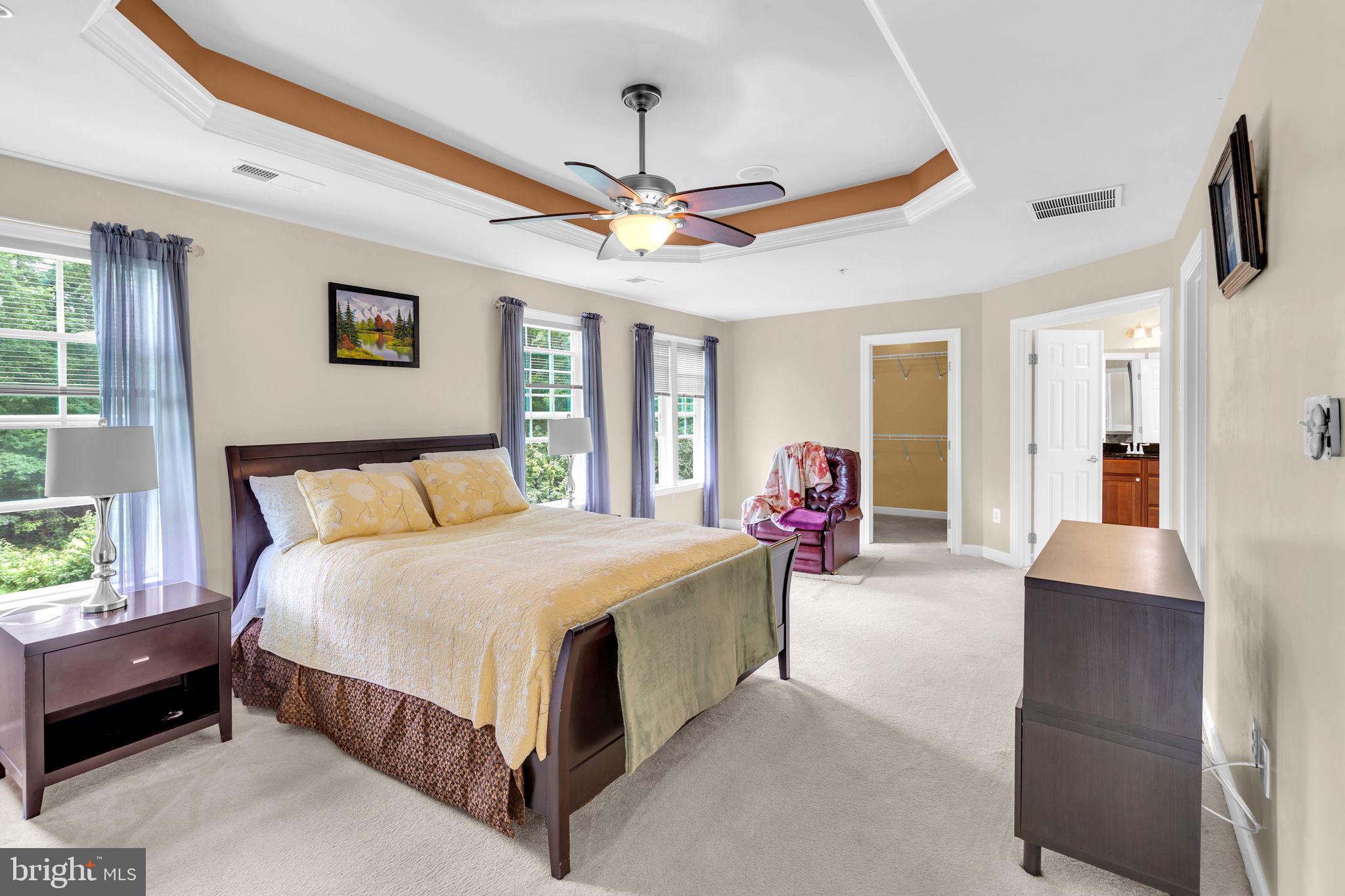 906 Gladway Road Baltimore, MD 21220 - Photo 14 of 52 a spacious bedroom with a bed and a chandelier