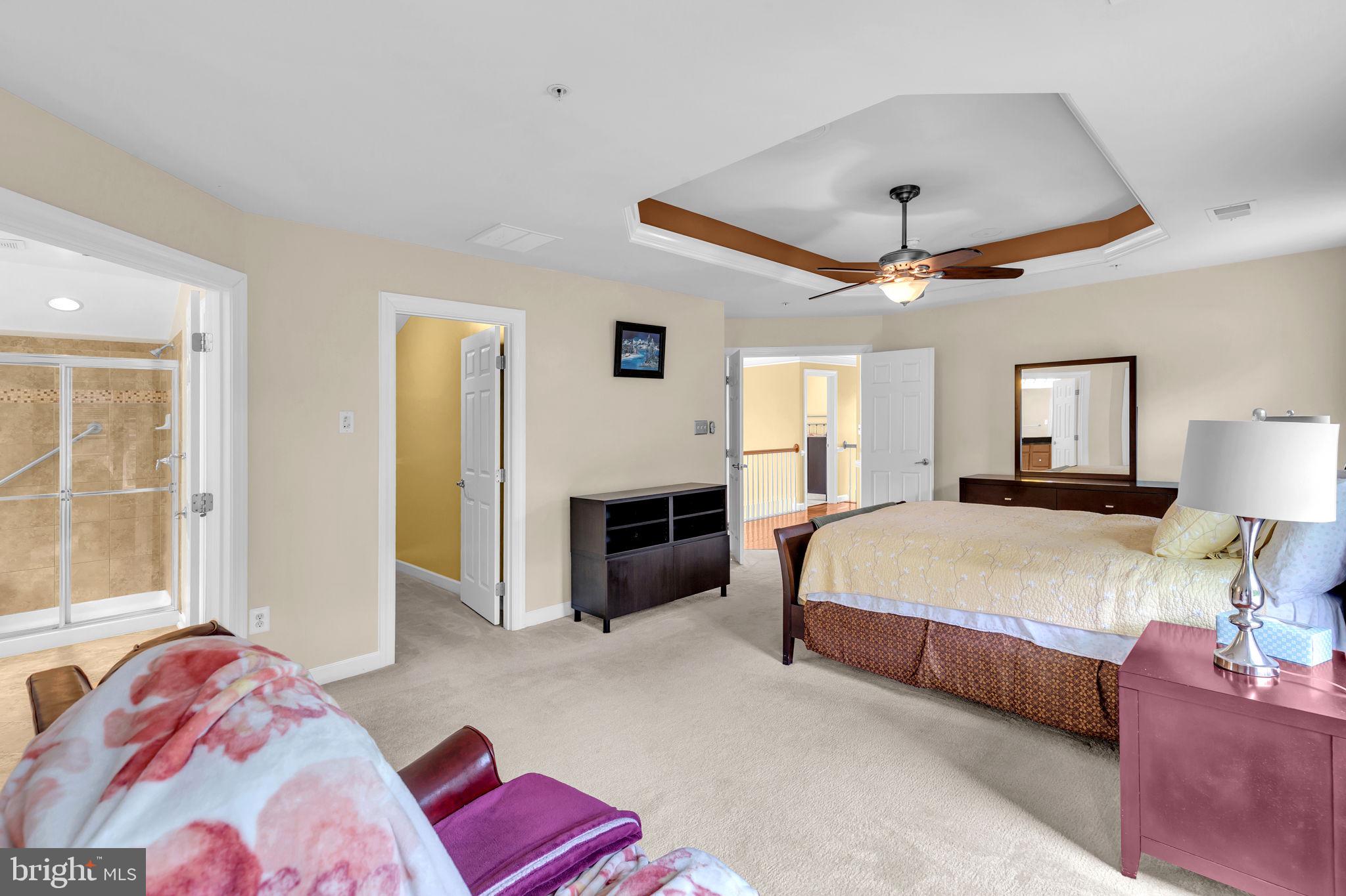 906 Gladway Road Baltimore, MD 21220 - Photo 15 of 52 a spacious bedroom with a bed and a chandelier