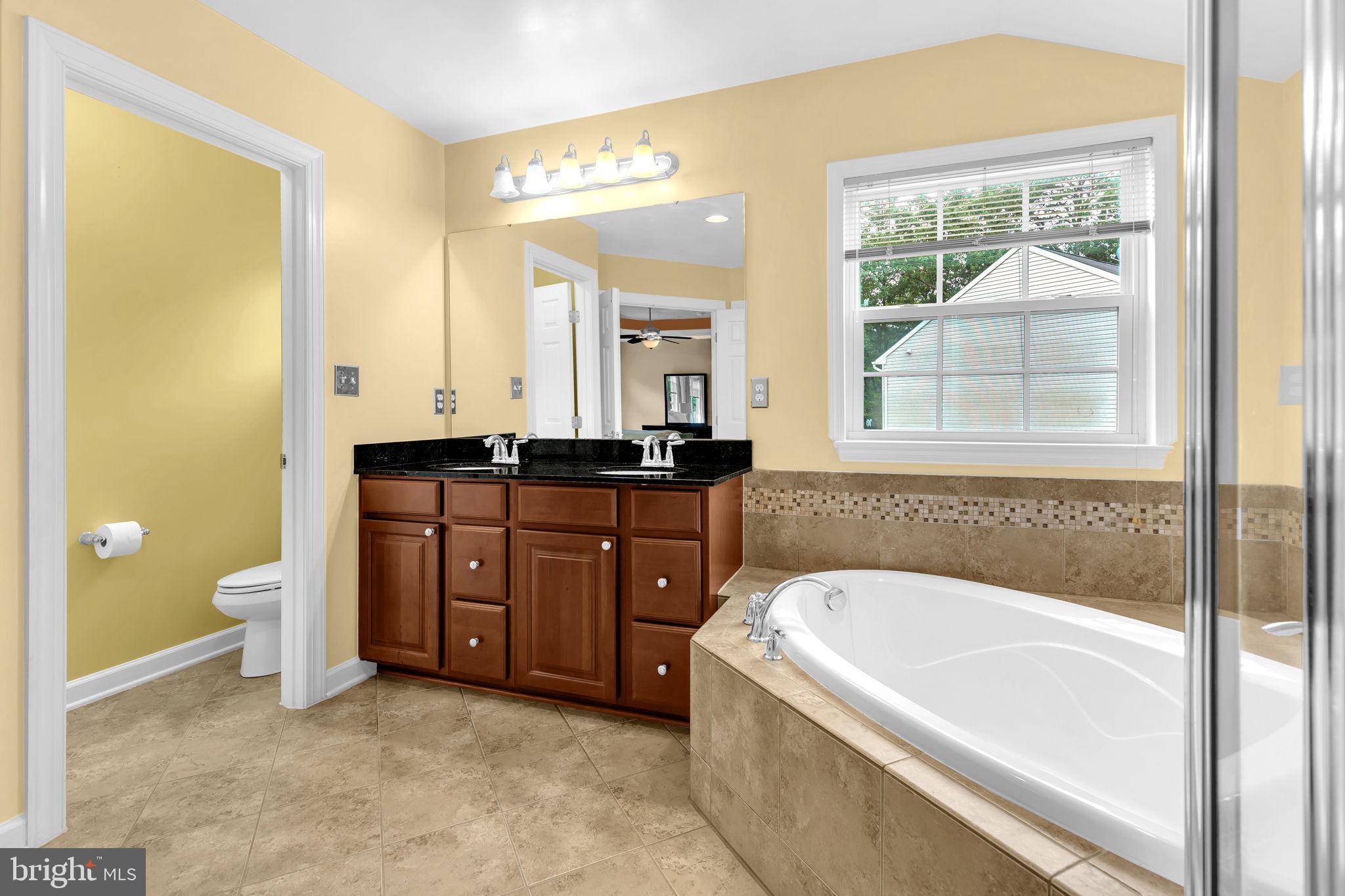 906 Gladway Road Baltimore, MD 21220 - Photo 19 of 52 a bathroom with a tub a sink and a window