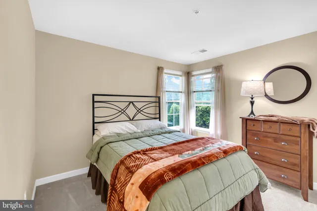 a bedroom with a bed and a mirror