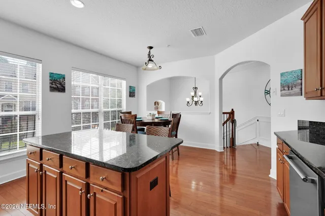 a kitchen with granite countertop a sink cabinets and window