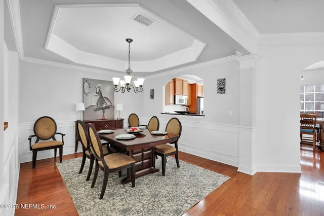 a dining room with furniture and wooden floor