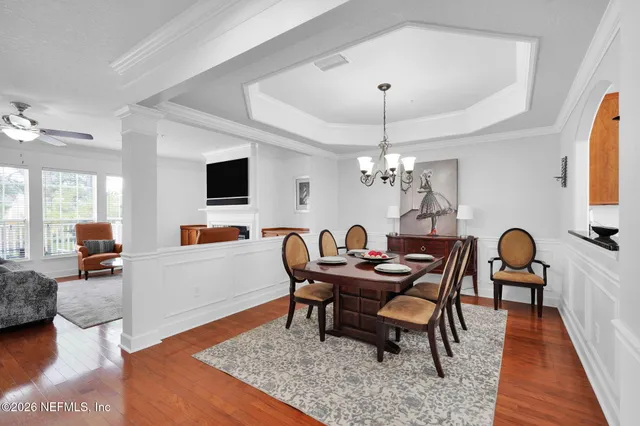 a view of a dining room with furniture and wooden floor