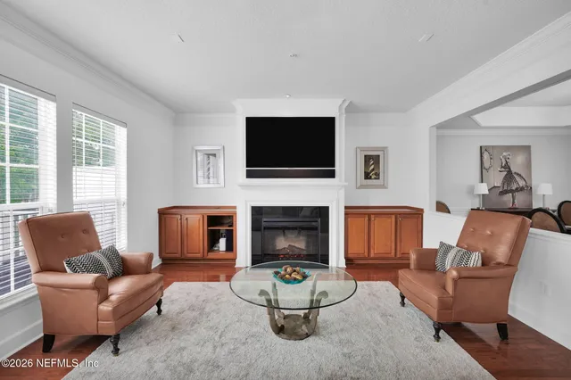 a living room with furniture a fireplace and a flat screen tv