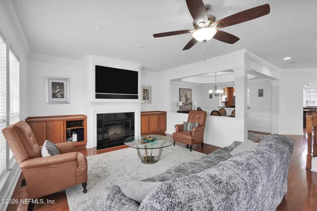 a living room with furniture a fireplace and a flat screen tv
