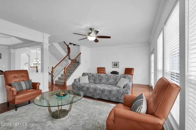 a living room with furniture and a chandelier