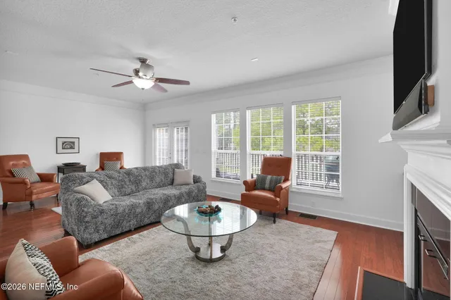 a living room with furniture a fireplace and a flat screen tv