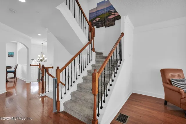 a view of entryway and hall with wooden floor