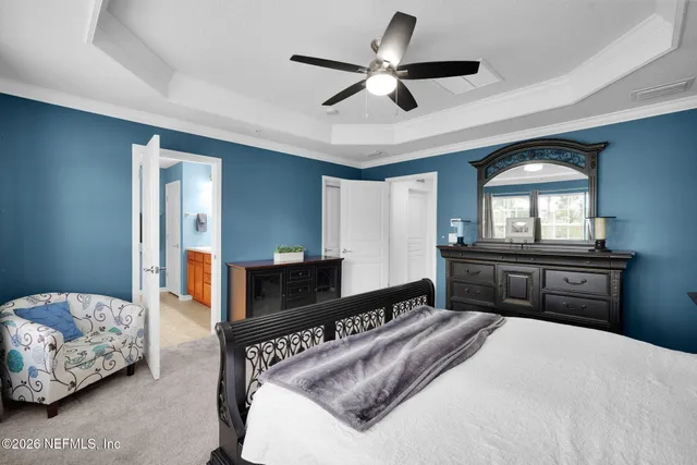 a bedroom with a large bed and a tv