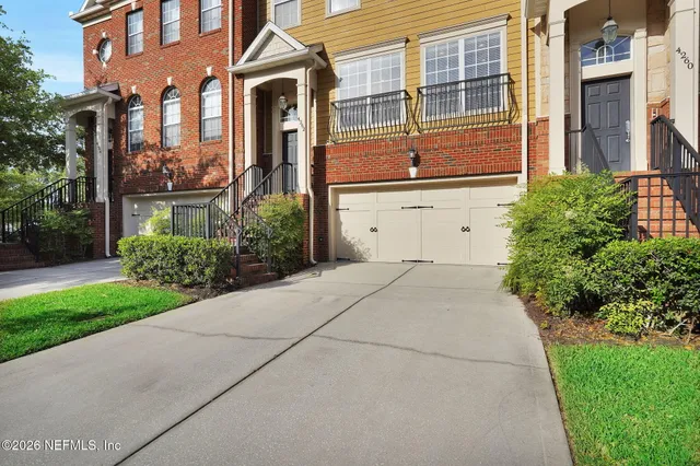 a front view of a building with a yard