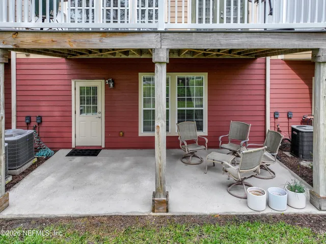 a view of a patio with table and chairs and potted plants