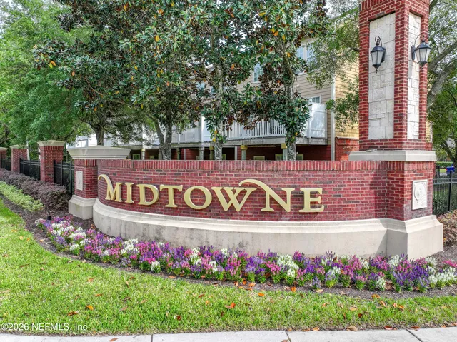 an aerial view of a house with swimming pool and a garden