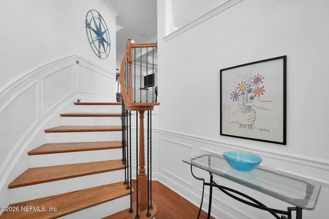 a view of entryway with furniture and wooden floor