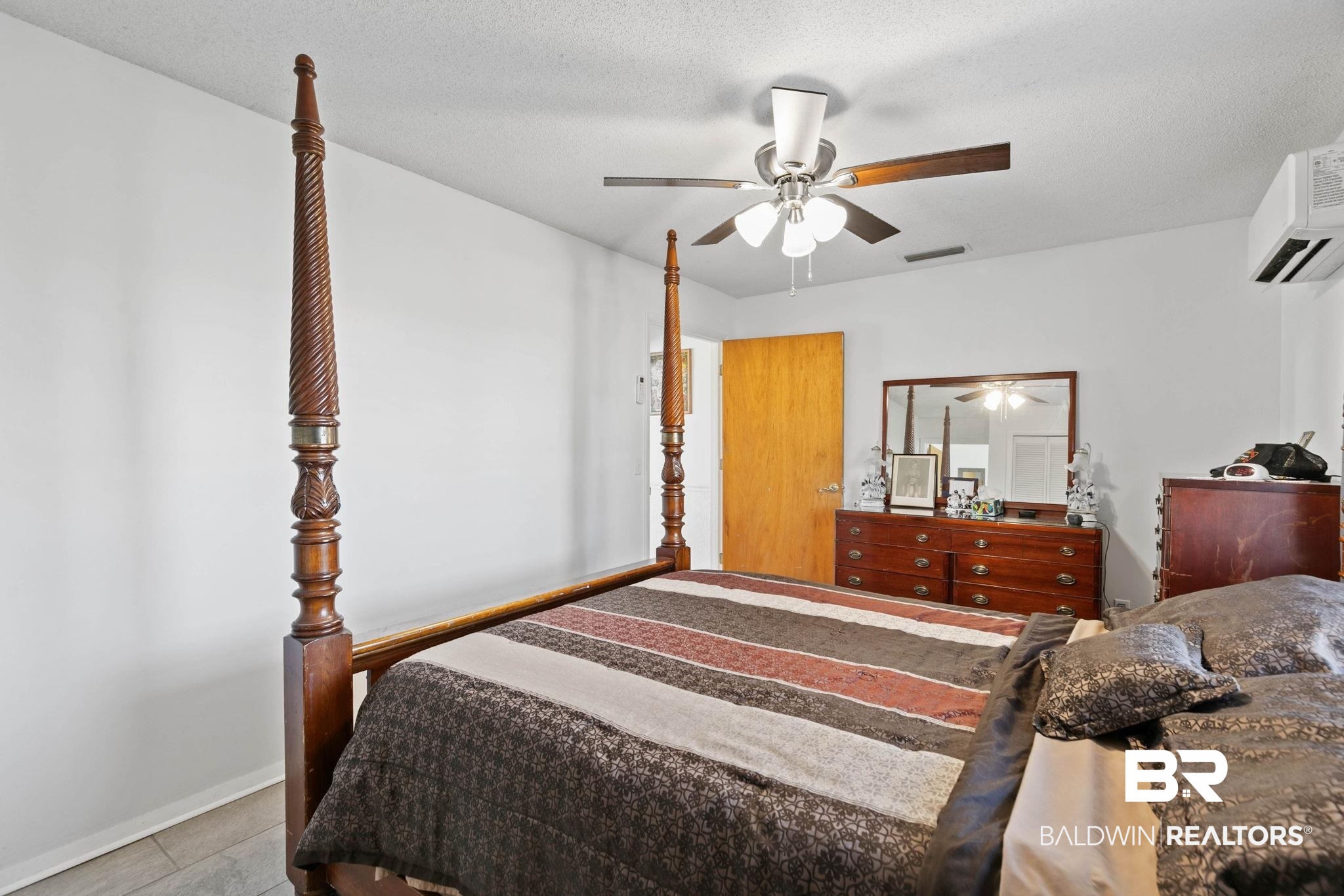 21267 Loop Road Andalusia, AL 36421 - Photo 32 of 72 Tiled bedroom featuring ceiling fan, a textured ceiling, and a wall mounted air conditioner
