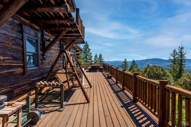 a view of balcony with wooden floor and fence