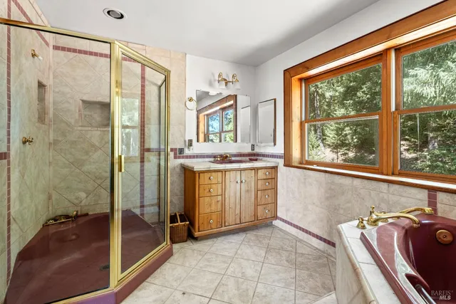 a bathroom with a granite countertop sink a shower and a mirror