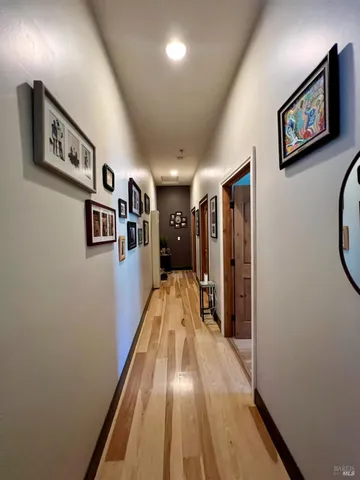 a view of a hallway with paintings on the wall