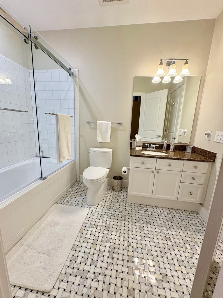 1201 Front Avenue Columbus, GA 31901 - Photo 11 of 16 a bathroom with a sink a toilet and mirror