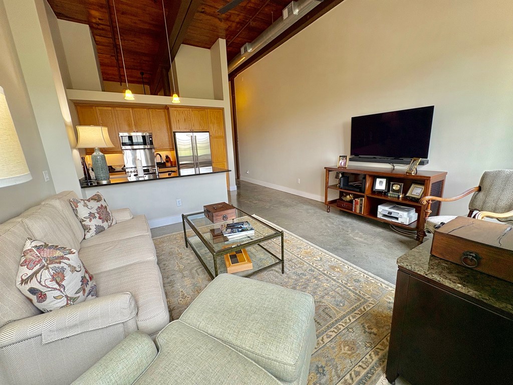 1201 Front Avenue Columbus, GA 31901 - Photo 15 of 16 a living room with furniture and a flat screen tv