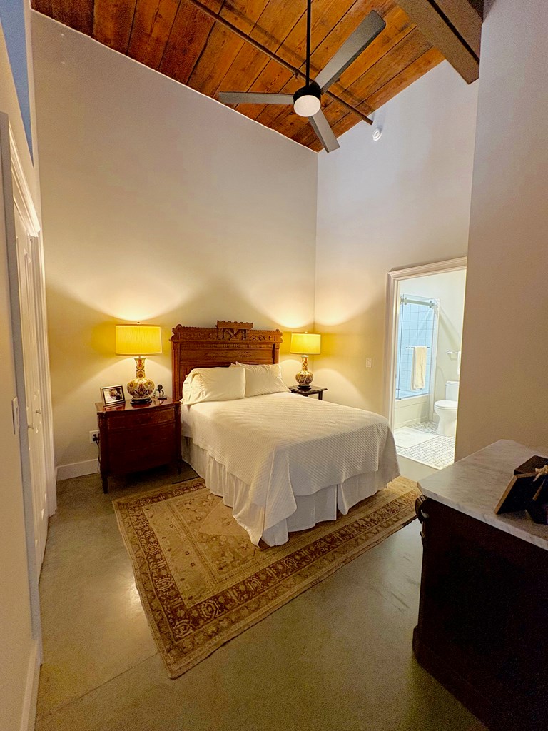 1201 Front Avenue Columbus, GA 31901 - Photo 9 of 16 a bed room with a bed and a couch