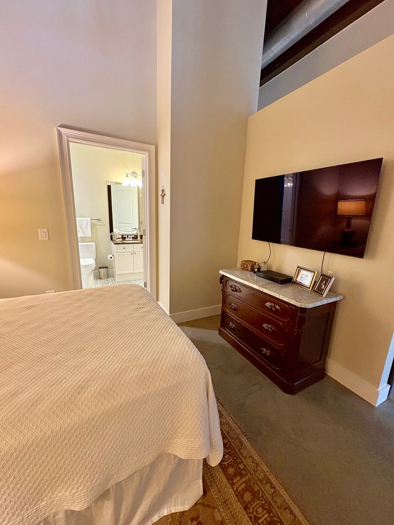 1201 Front Avenue Columbus, GA 31901 - Photo 10 of 16 a bedroom with a bed and a flat screen tv