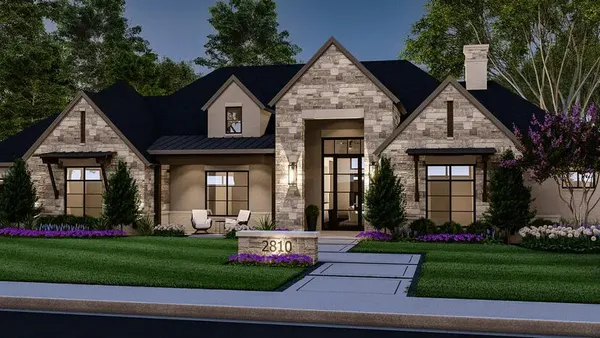 a front view of a house with a yard and potted plants