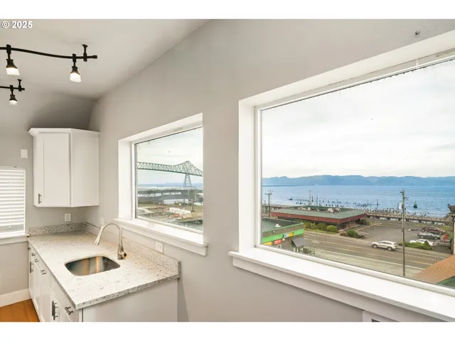 a kitchen with a window and a view of living room