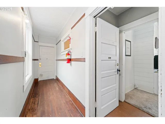 a view of an entryway with wooden floor