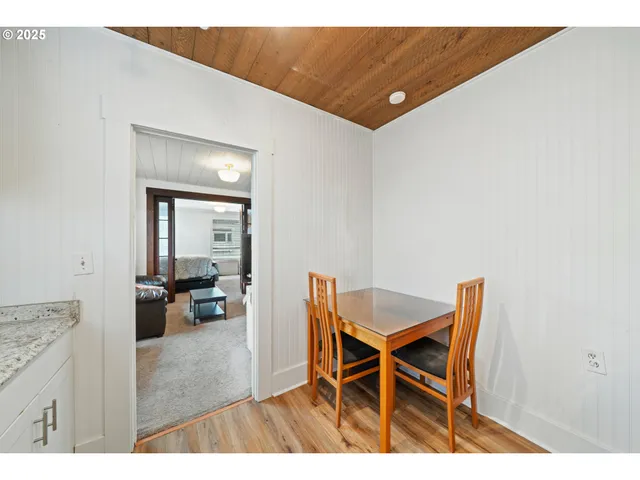 a dining room with furniture and wooden floor
