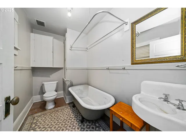 a bathroom with a sink a toilet and a mirror