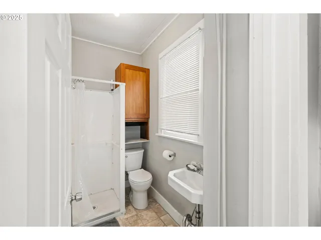a bathroom with a toilet a sink and a mirror